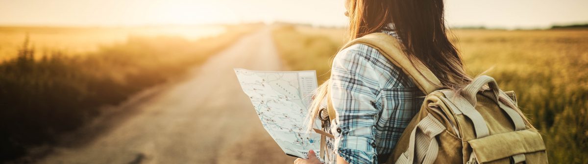 Attractive backpacker girl looking map
