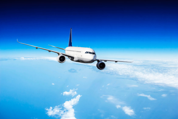 commercial-jet-plane-flying-above-clouds-istock_94634997_xlarge-2-585x390