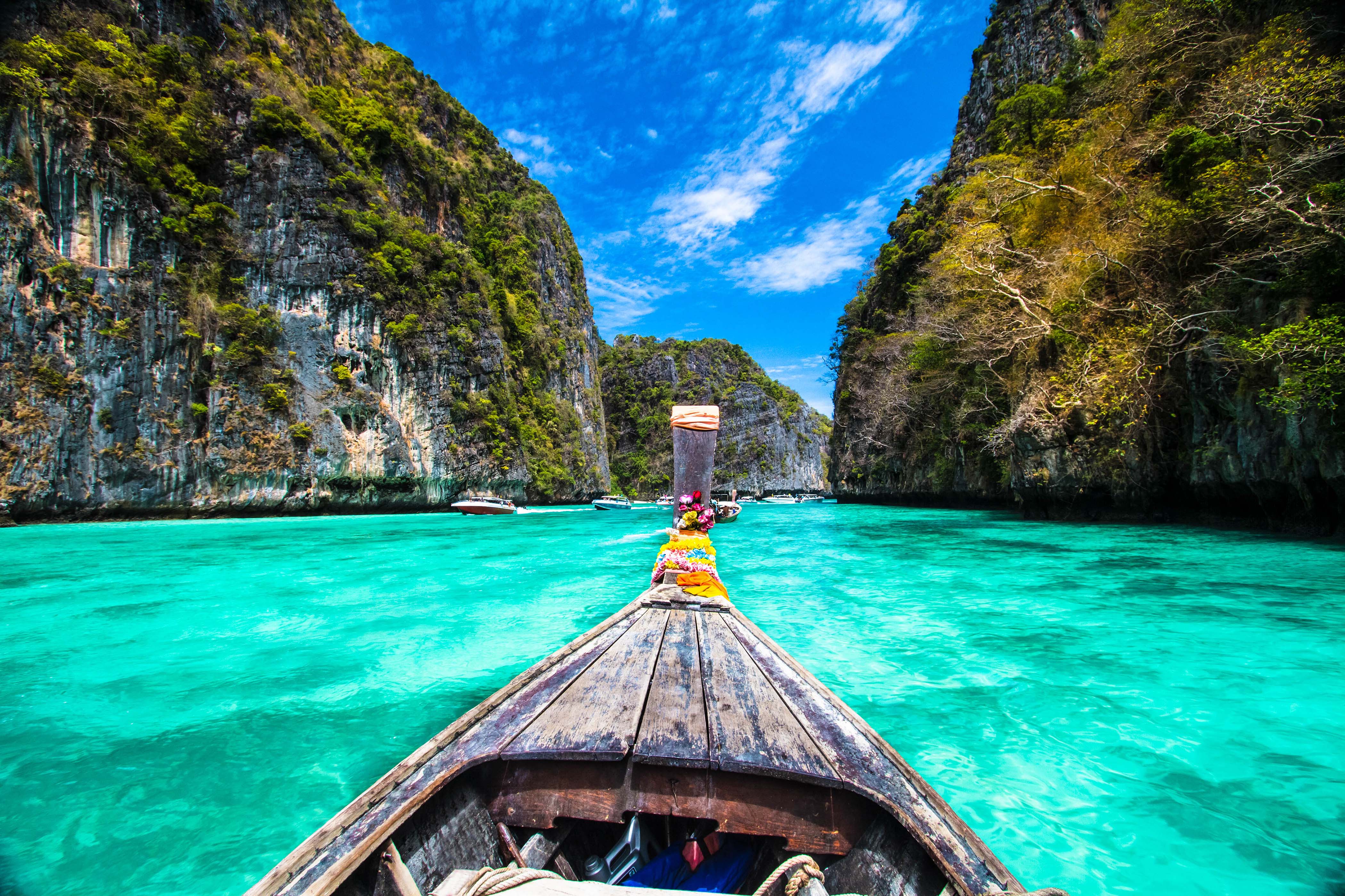 Traditional wooden boat in a picture perfect tropical bay on Koh Phi Phi Island, Thailand, Asia.