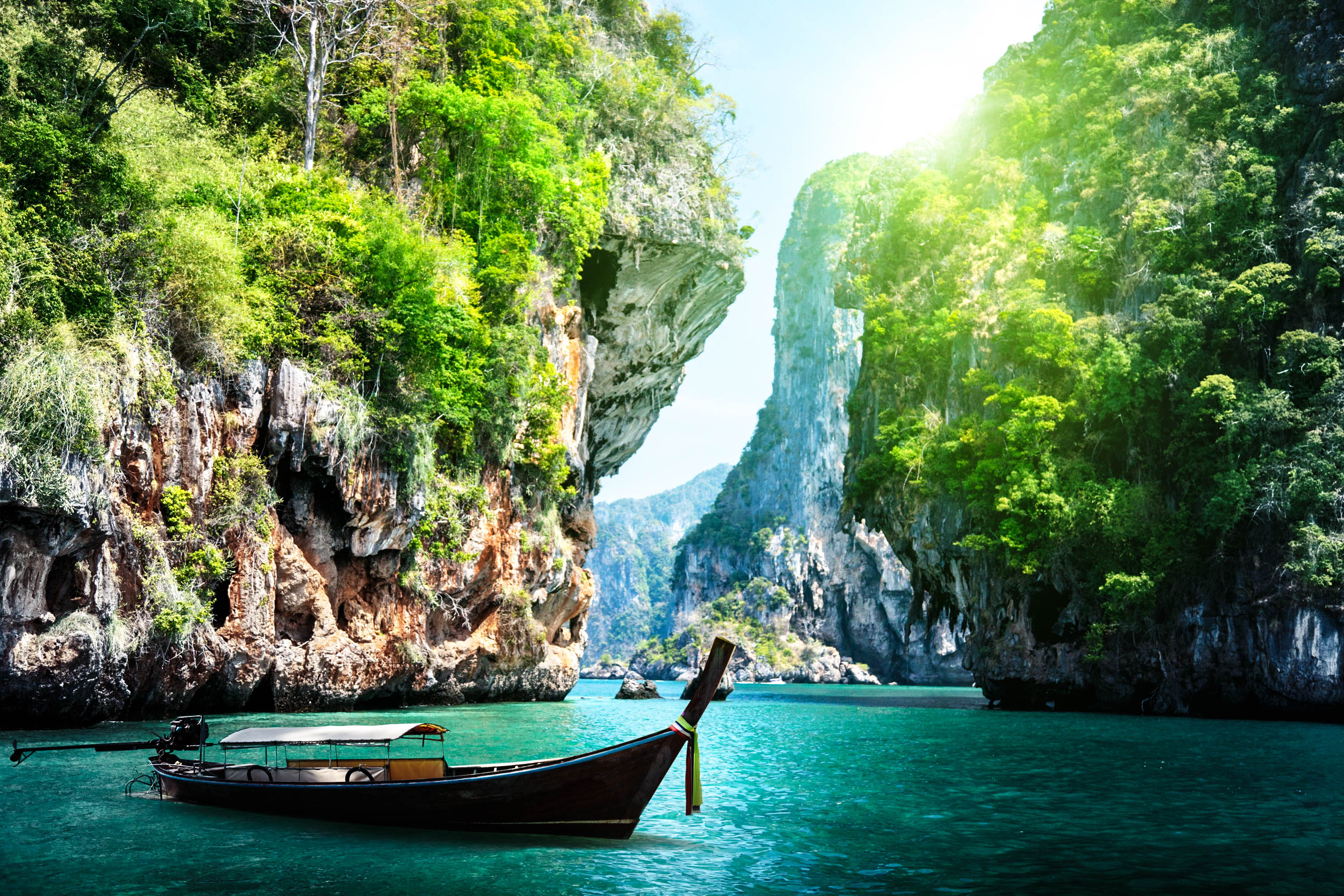 long-boat-and-rocks-on-railay-beach-in-krabi-thailand-shutterstock_125319602-2