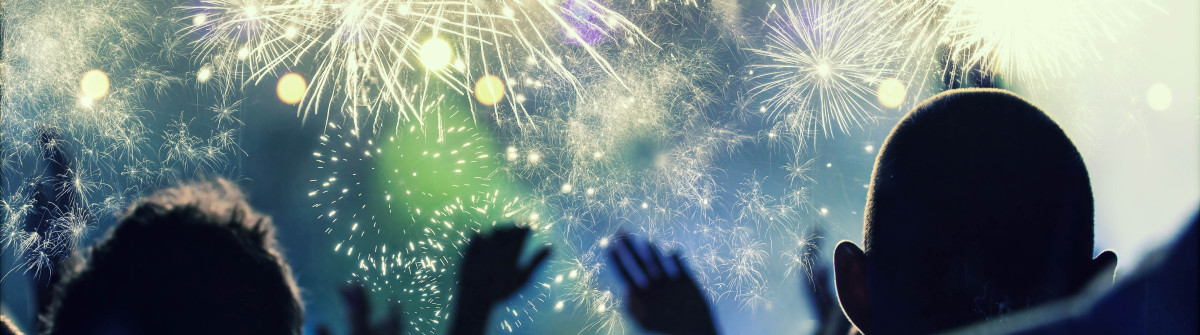 New Year concept – cheering crowd and fireworks