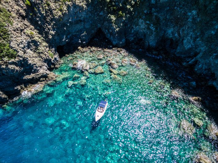 ischia-lonely-boat-in-a-turquoise-naples-italyshutterstock_469607711-2