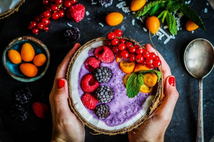 berry-smoothie-with-berries-in-coconut-on-rustic-background-shutterstock_390096700-2-1-e1576681078725