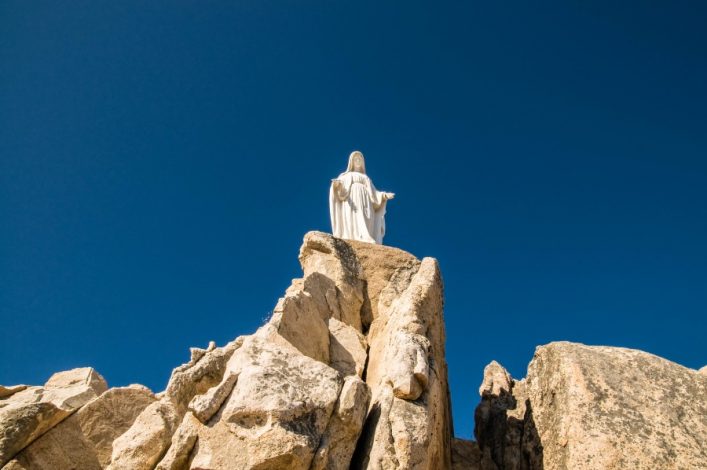 notre-dame-statue-of-the-virgin-mary-on-a-rock-shutterstock_17946625-2
