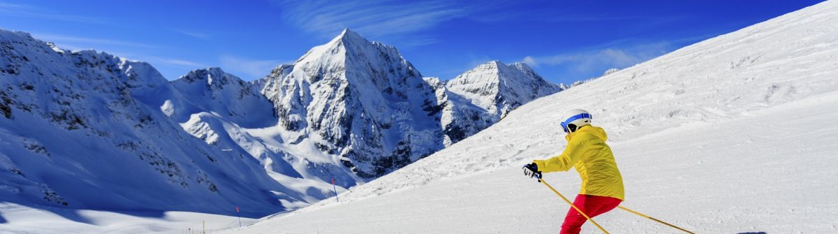 Ski, skier on ski run – woman skiing downhill, winter sport