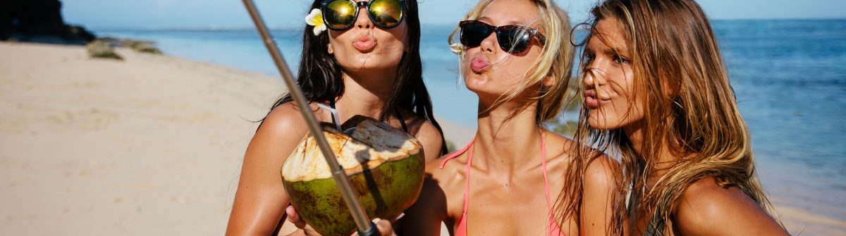 Women pouting for selfie on the beach